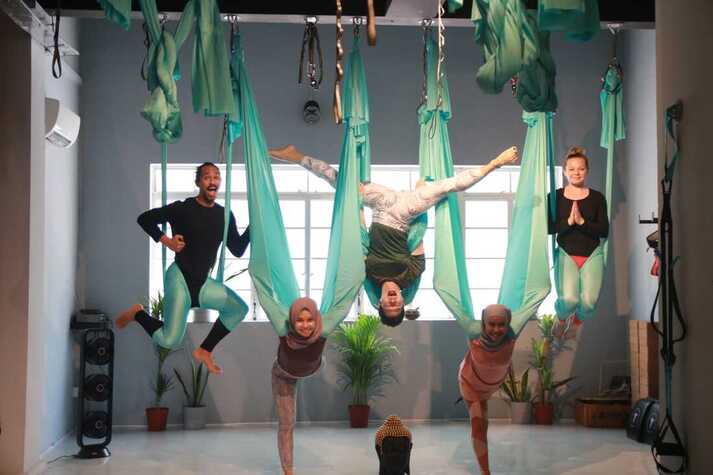 4 aerial teacher in different poses with multicultural background
