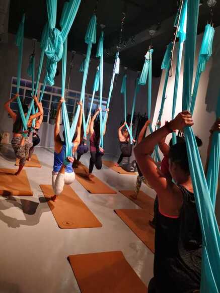 Aerial fitness class with blue hammocks at movement Sports medicine centre singapore