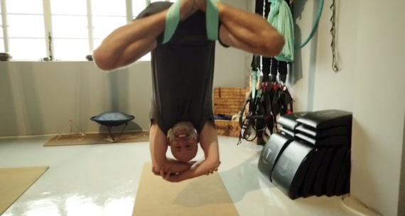 Male caucasian client doing aerial fitness inversion at movement & sports medicine centre