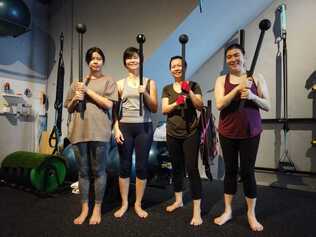 4 females holding a mcaebell in movement & sports medicine centre Singapore